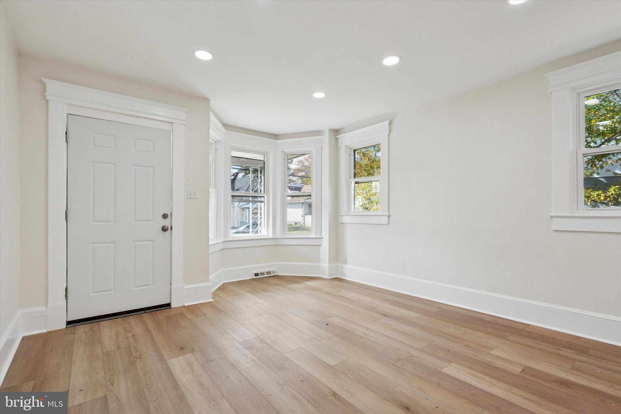 260 Weber Avenue Ewing, NJ 08638 - Photo 4 of 25 an empty room with wooden floor and windows