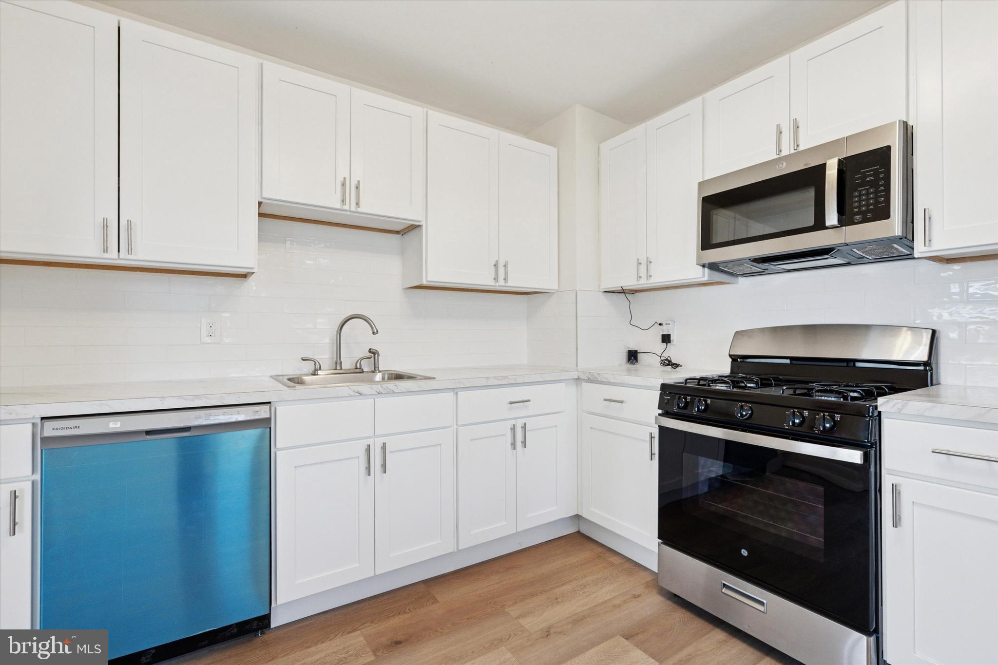 260 Weber Avenue Ewing, NJ 08638 - Photo 10 of 25 a kitchen with stainless steel appliances granite countertop grey cabinets a stove a sink and dishwasher