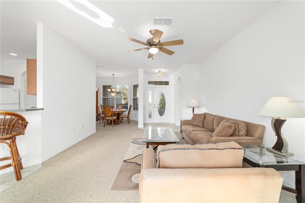8404 Southwest 82nd Circle Ocala, FL 34481 - Photo 16 of 58 a living room with furniture and a chandelier
