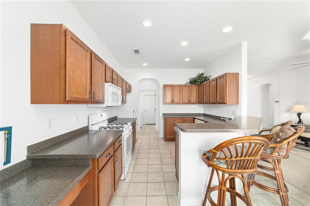 8404 Southwest 82nd Circle Ocala, FL 34481 - Photo 24 of 58 a kitchen with stainless steel appliances granite countertop table chairs sink and cabinets