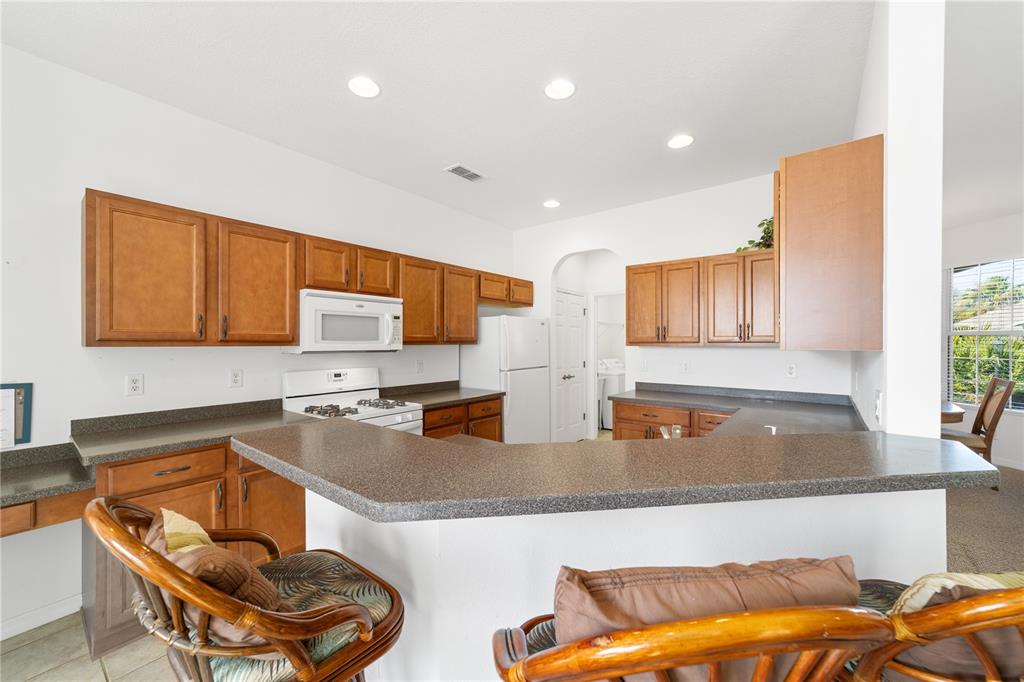 8404 Southwest 82nd Circle Ocala, FL 34481 - Photo 25 of 58 a kitchen with stainless steel appliances granite countertop a sink and a refrigerator