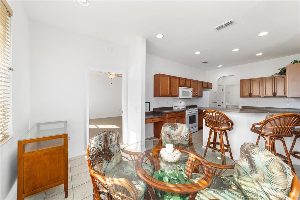 8404 Southwest 82nd Circle Ocala, FL 34481 - Photo 27 of 58 a kitchen with stainless steel appliances kitchen island granite countertop a table and chairs in it