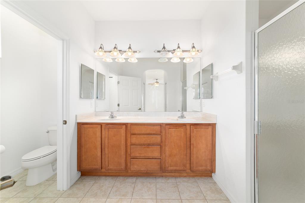 8404 Southwest 82nd Circle Ocala, FL 34481 - Photo 35 of 58 a spacious bathroom with a double vanity sink and a mirror
