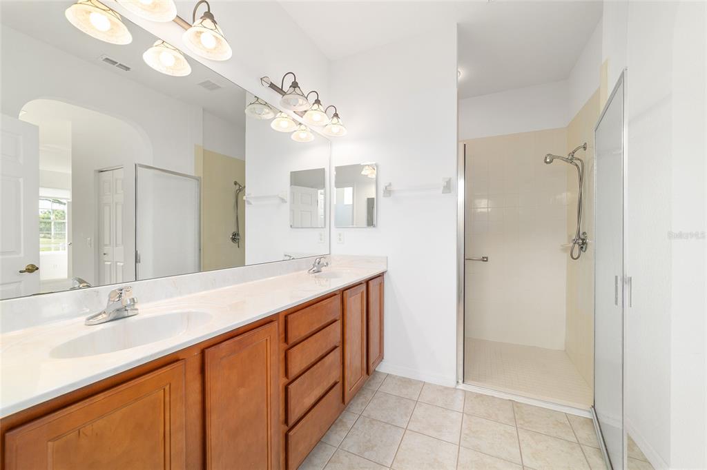 8404 Southwest 82nd Circle Ocala, FL 34481 - Photo 36 of 58 a bathroom with a double vanity sink mirror and shower