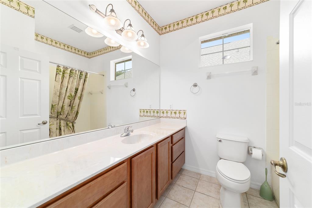 8404 Southwest 82nd Circle Ocala, FL 34481 - Photo 44 of 58 a bathroom with a sink a toilet a mirror and shower
