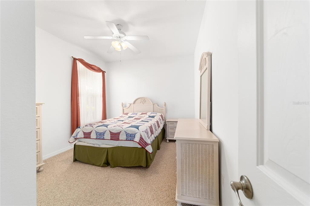 8404 Southwest 82nd Circle Ocala, FL 34481 - Photo 46 of 58 a bedroom with a bed and a chandelier