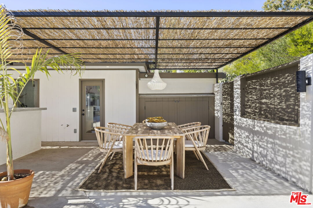 431 Montana Circle Ojai, CA 93023 - Photo 24 of 73 a view of a patio with table and chairs with wooden floor and fence