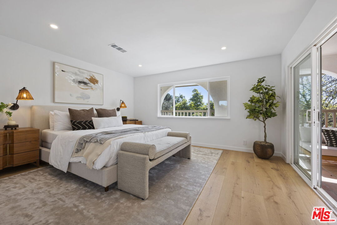 431 Montana Circle Ojai, CA 93023 - Photo 30 of 73 a spacious bedroom with a large bed and a potted plant