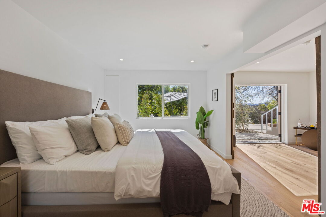 431 Montana Circle Ojai, CA 93023 - Photo 39 of 73 a bedroom with a balcony a large bed and a large window