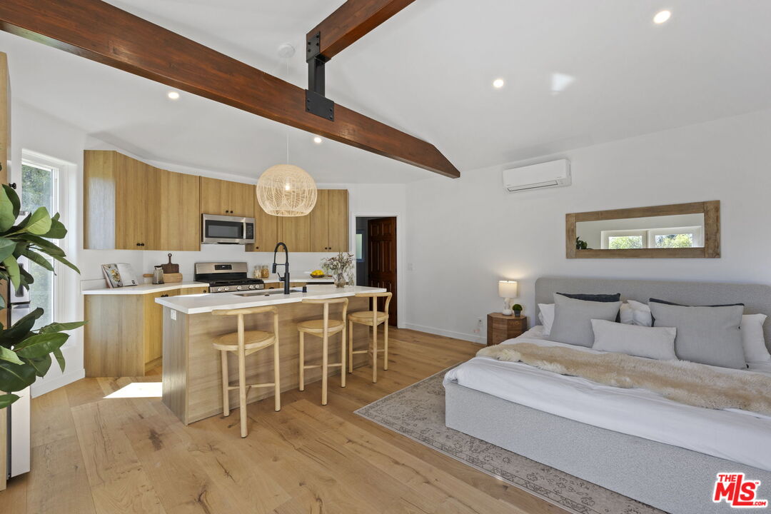 431 Montana Circle Ojai, CA 93023 - Photo 48 of 73 a large white kitchen with a large island oven a stove a dining table and chairs