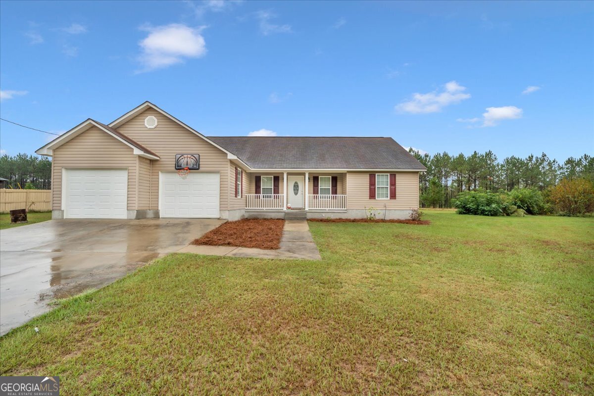 a front view of a house with yard and green space
