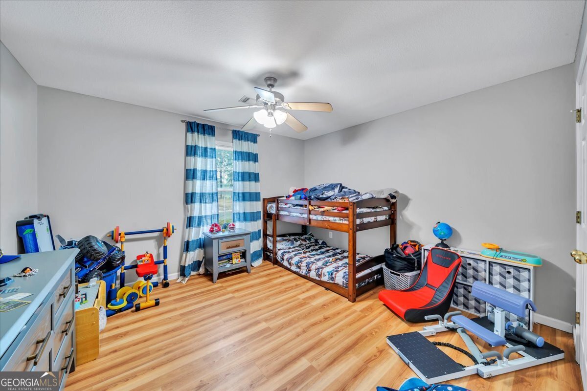 1004 Robertson Church Road Dublin, GA 31021 - Photo 11 of 12 a bedroom with furniture and a gym equipment