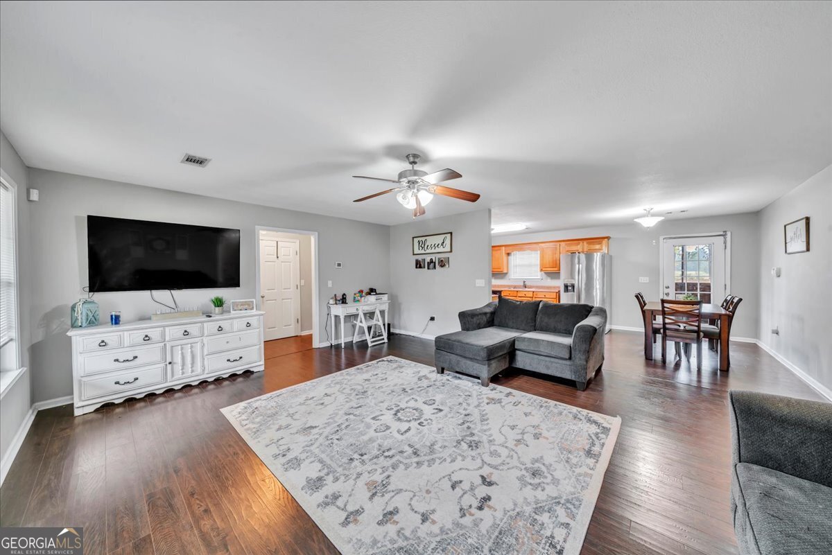1004 Robertson Church Road Dublin, GA 31021 - Photo 2 of 12 a living room with furniture and a flat screen tv