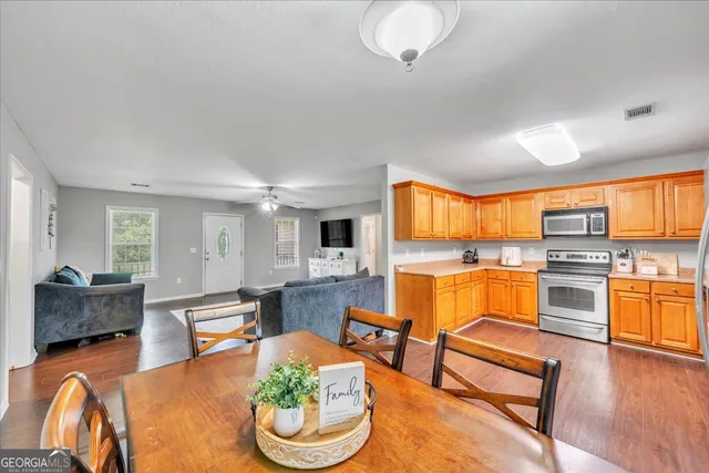 a living room with furniture and a kitchen