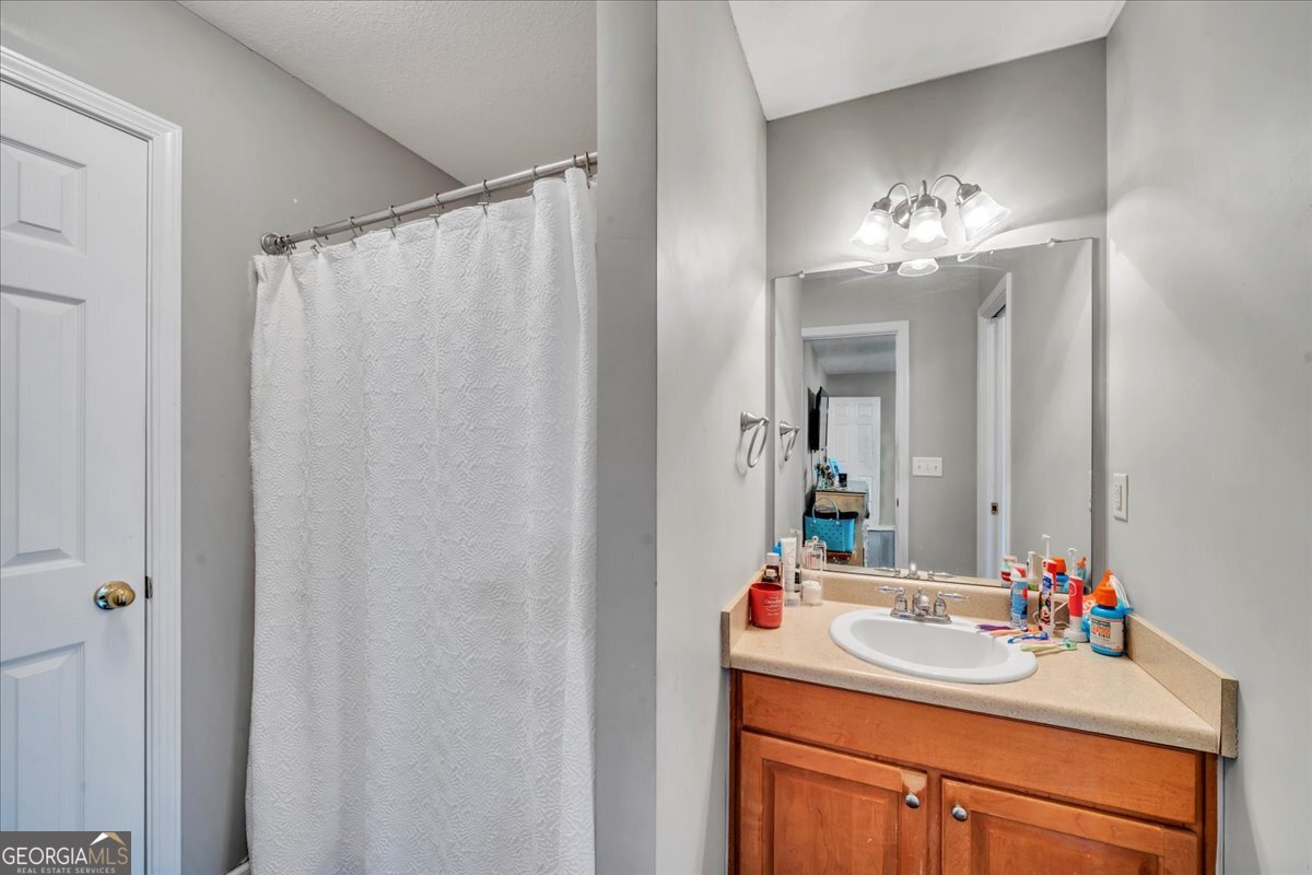 1004 Robertson Church Road Dublin, GA 31021 - Photo 7 of 12 a bathroom with a sink vanity and a mirror