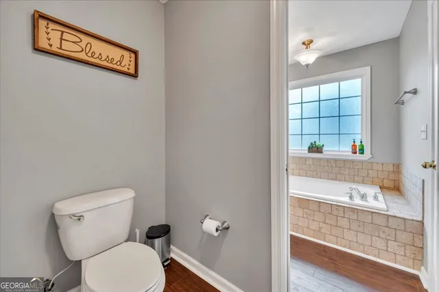 a bathroom with a toilet a sink and a shower