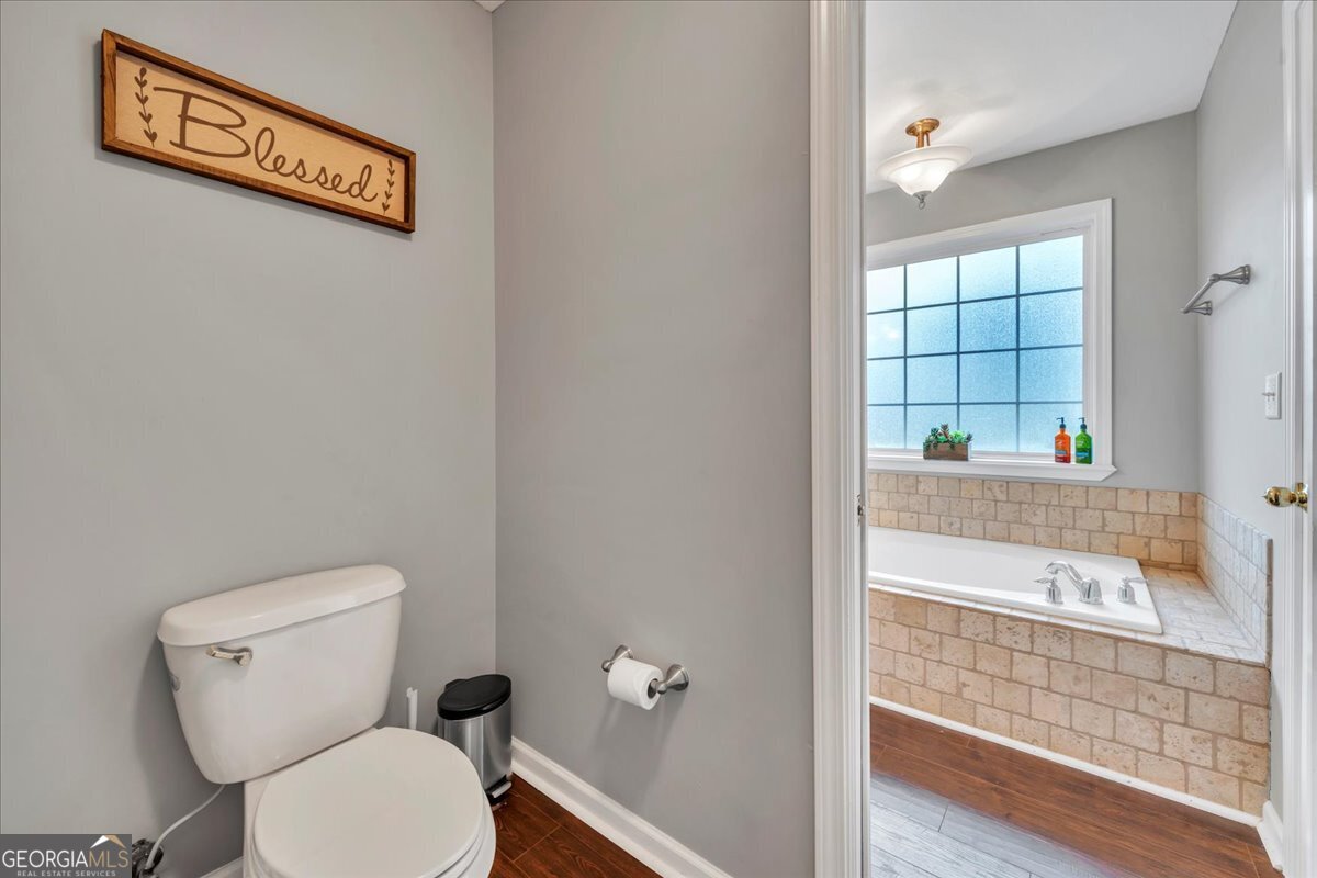 1004 Robertson Church Road Dublin, GA 31021 - Photo 9 of 12 a bathroom with a toilet a sink and a shower