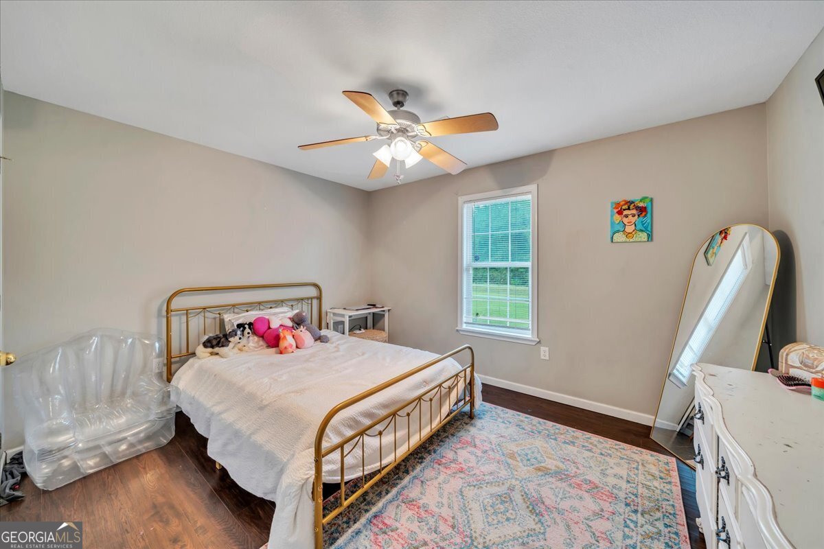 1004 Robertson Church Road Dublin, GA 31021 - Photo 10 of 12 a bedroom with a bed and a chandelier