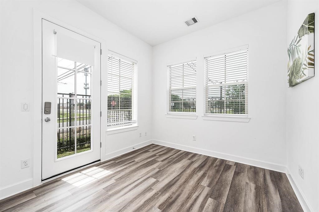 2103 Naomi Street, Unit A Houston, TX 77054 - Photo 15 of 19 a view of a livingroom with wooden floor and windows