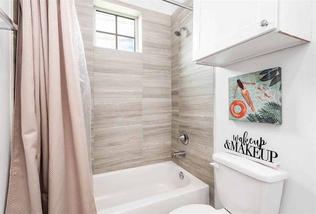 2103 Naomi Street, Unit A Houston, TX 77054 - Photo 17 of 19 a bathroom with a bathtub and a shower curtain