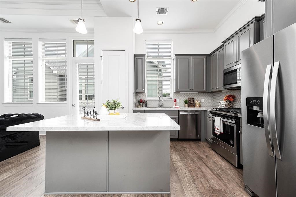 2103 Naomi Street, Unit A Houston, TX 77054 - Photo 4 of 19 a kitchen with stainless steel appliances granite countertop a sink stove and refrigerator