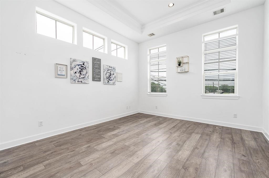 2103 Naomi Street, Unit A Houston, TX 77054 - Photo 9 of 19 an empty room with wooden floor and windows