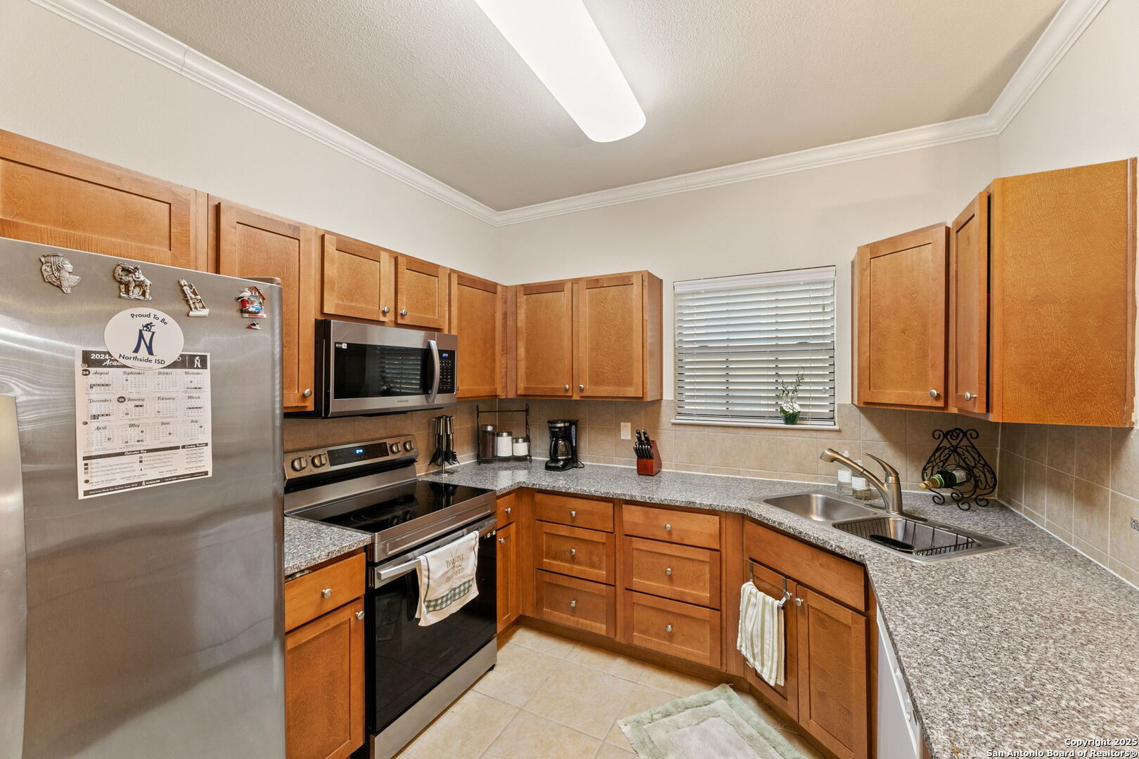 6160 Eckhert Road, Unit 204 San Antonio, TX 78240 - Photo 13 of 30 a kitchen with stainless steel appliances granite countertop a sink a stove and a refrigerator