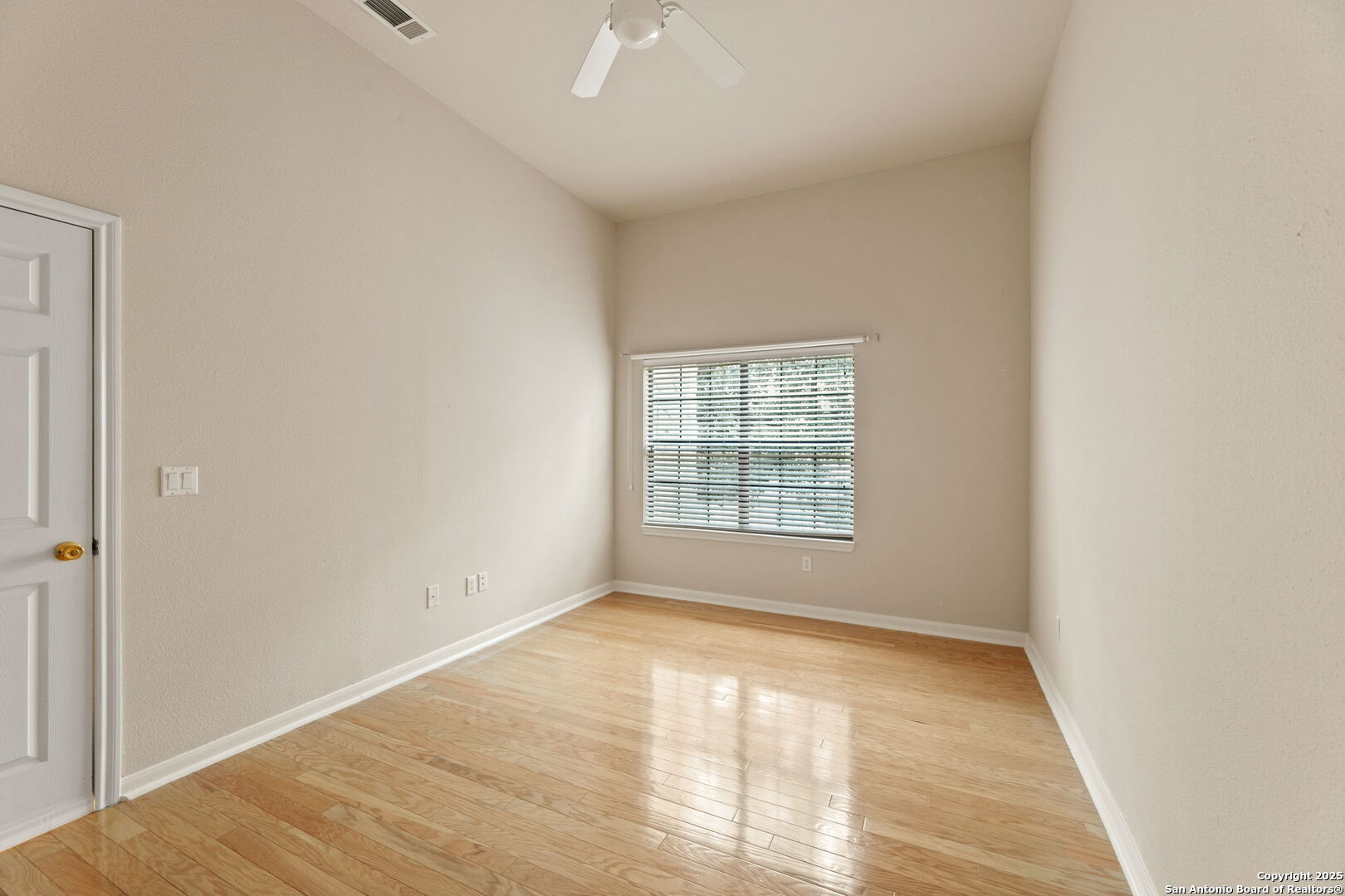 6160 Eckhert Road, Unit 204 San Antonio, TX 78240 - Photo 17 of 30 a view of empty room with wooden floor and fan
