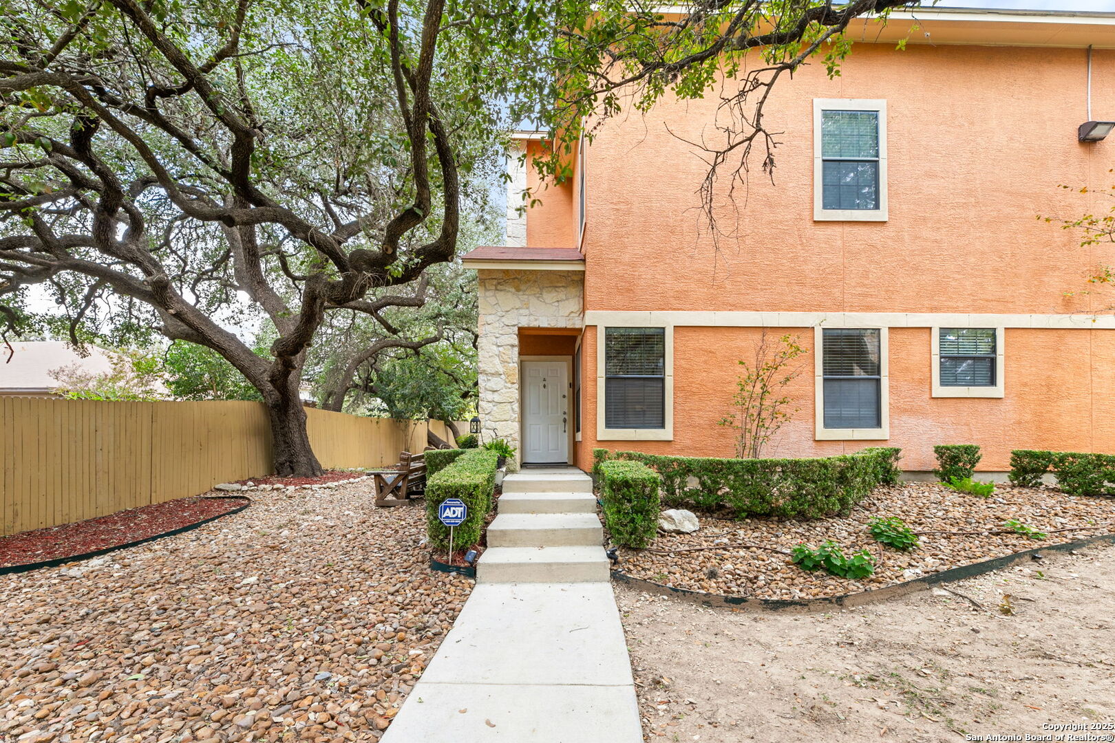 6160 Eckhert Road, Unit 204 San Antonio, TX 78240 - Photo 2 of 30 front view of a house with a yard and potted plants