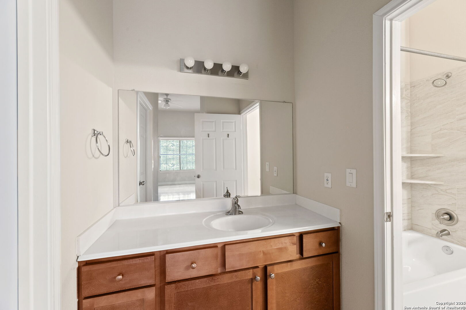 6160 Eckhert Road, Unit 204 San Antonio, TX 78240 - Photo 22 of 30 a bathroom with a sink and a mirror