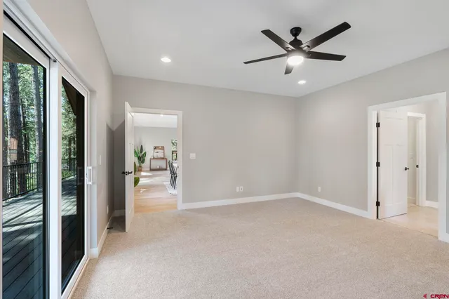 wooden floor in an empty room with a ceiling fan