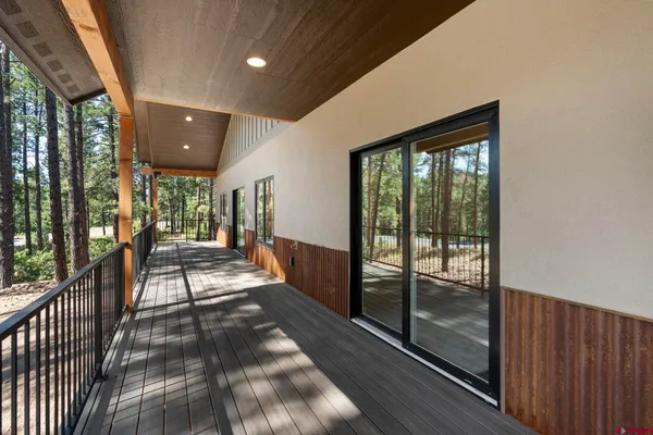 an empty room with a ceiling fan and windows