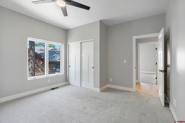 an empty room with windows and closet