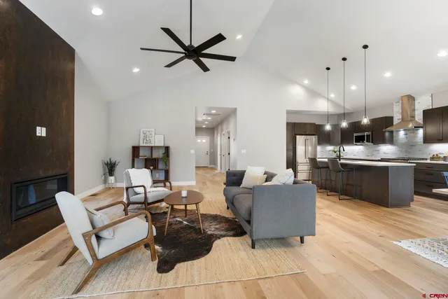 a living room with furniture and a view of kitchen