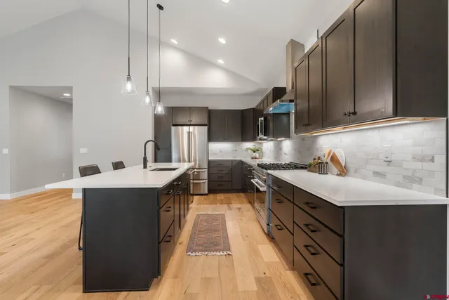 a kitchen with kitchen island a sink and a stove top oven