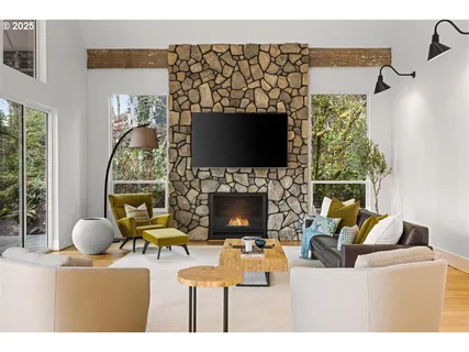 a living room with furniture a flat screen tv and a fireplace