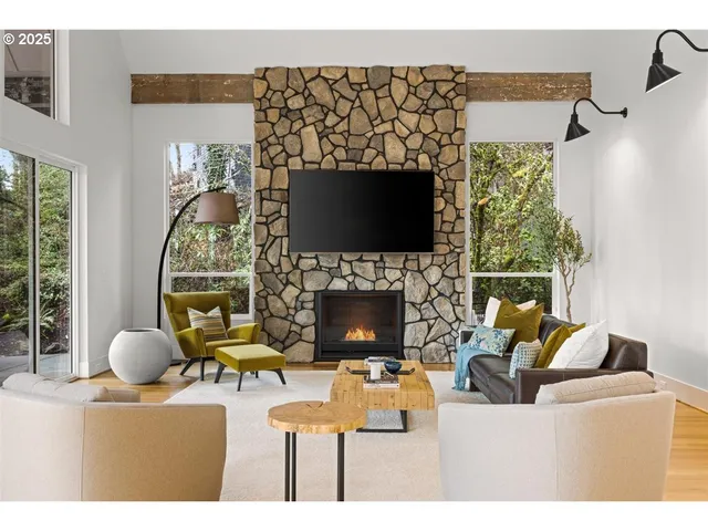 a living room with furniture a flat screen tv and a fireplace