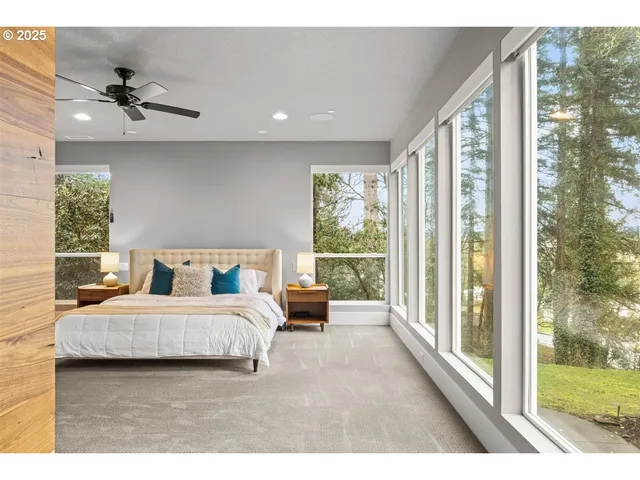 a bedroom with a large bed and a large window