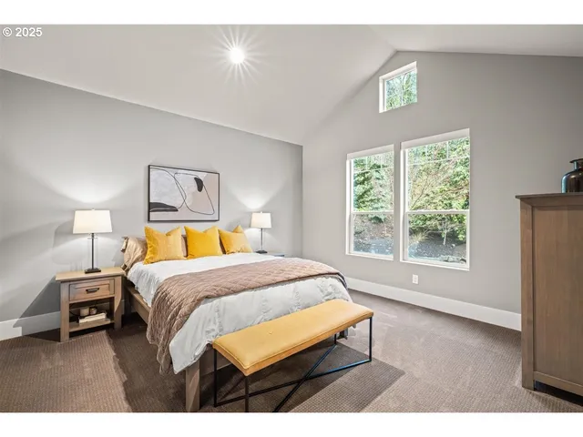 a bedroom with a bed a window and a lamp