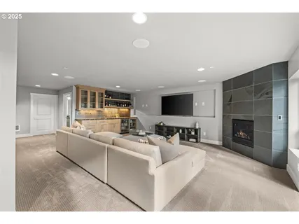 a living room with furniture a fireplace and a flat screen tv