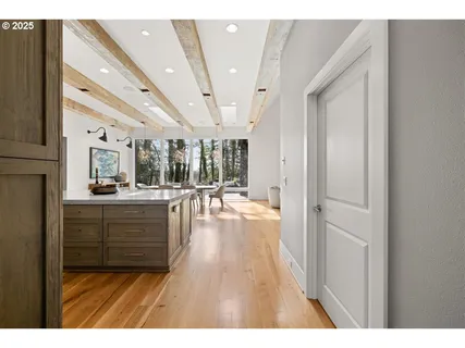 a open hall with wooden floor and windows