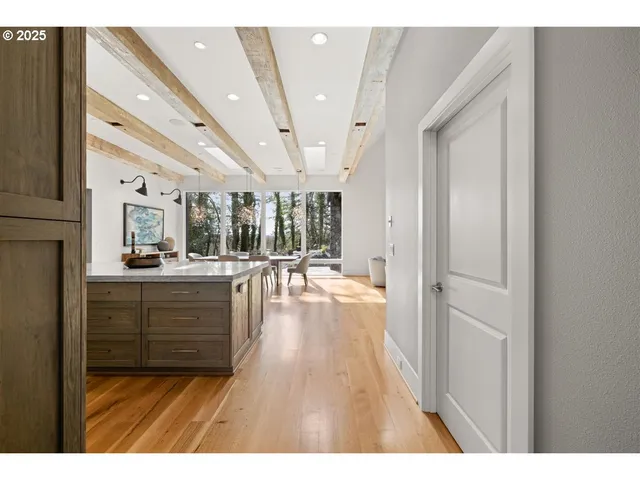 a open hall with wooden floor and windows
