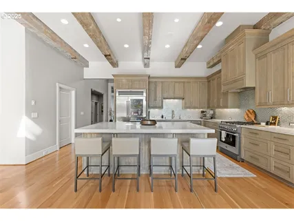 a dining hall with stainless steel appliances a dining table and chairs