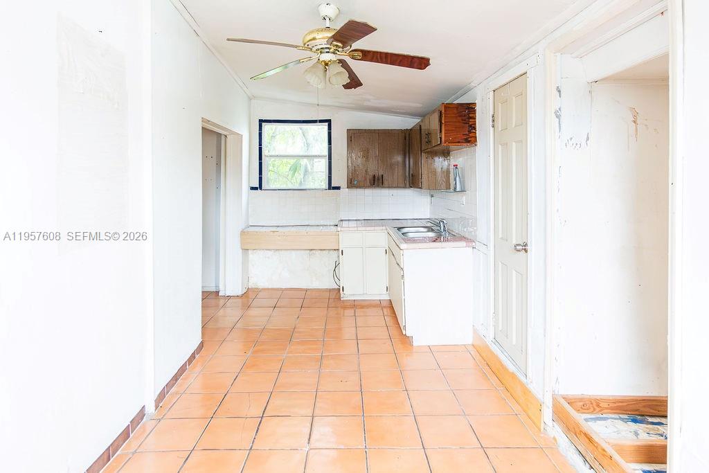 2345 Southwest 19th Street Miami, FL 33145 - Photo 20 of 21 a hallway with a white cabinets and chandelier