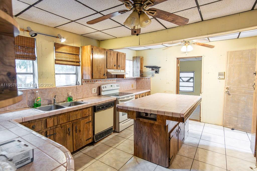 2345 Southwest 19th Street Miami, FL 33145 - Photo 3 of 21 a kitchen with a sink a counter top space and stainless steel appliances