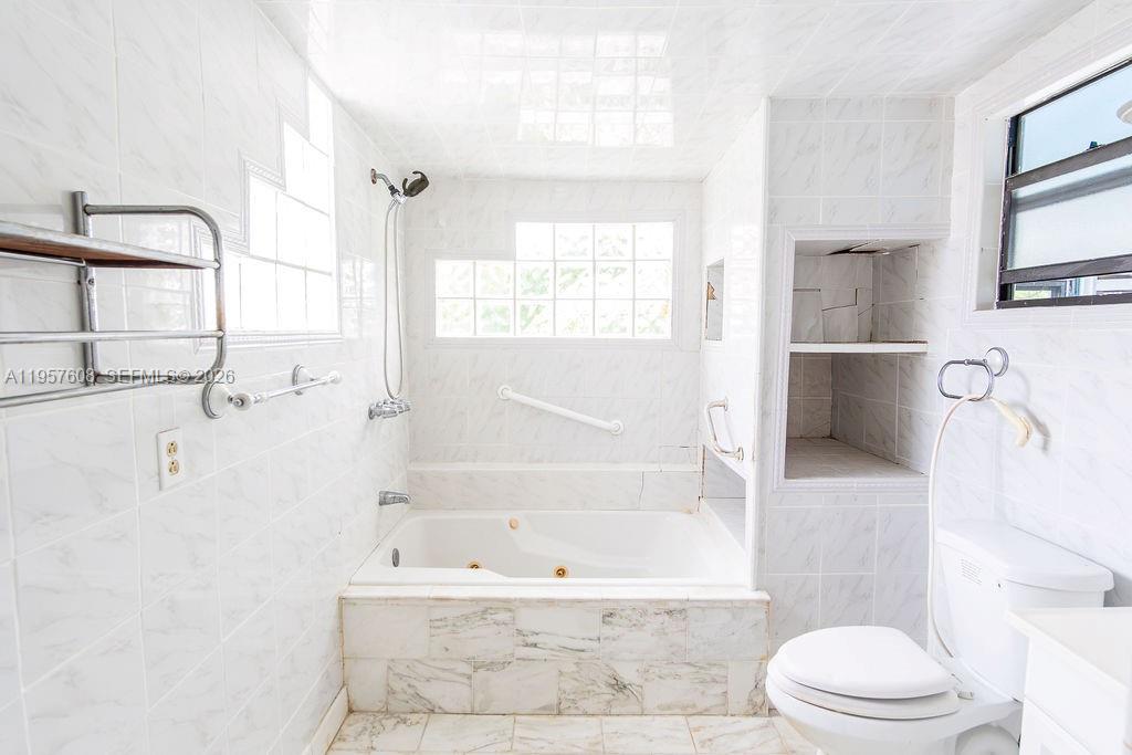 2345 Southwest 19th Street Miami, FL 33145 - Photo 8 of 21 a bathroom with a bathtub toilet and sink
