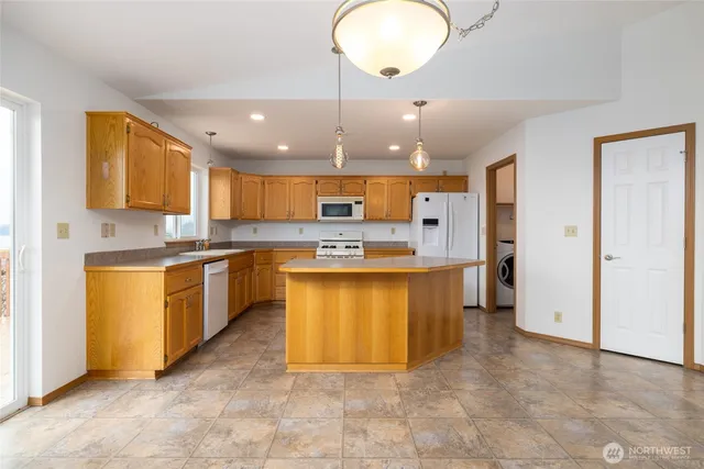 a kitchen with stainless steel appliances granite countertop a stove sink and cabinets