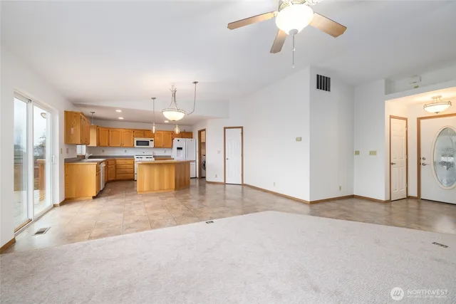 a view of a kitchen with a sink and a refrigerator