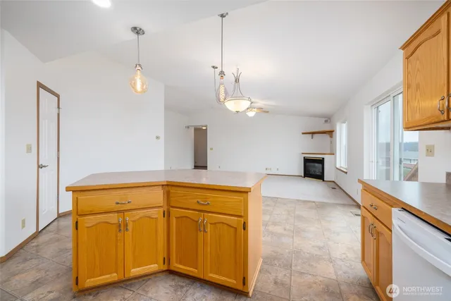 a view of a kitchen with a sink and dishwasher cabinet with wooden floor