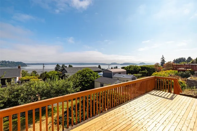 a view of a balcony with wooden fence
